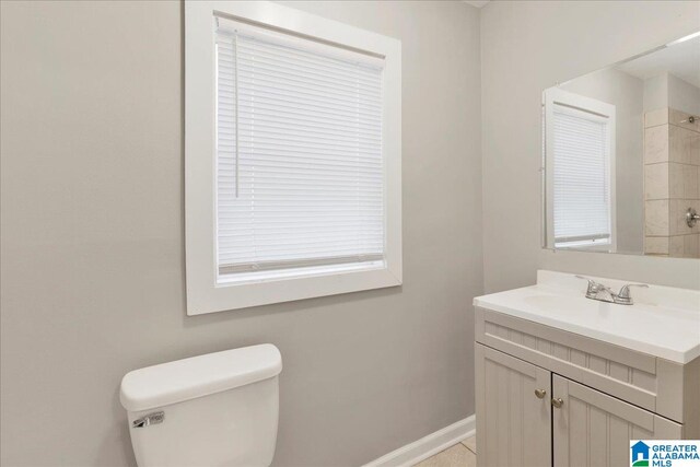 bathroom featuring tile patterned floors, vanity, and toilet