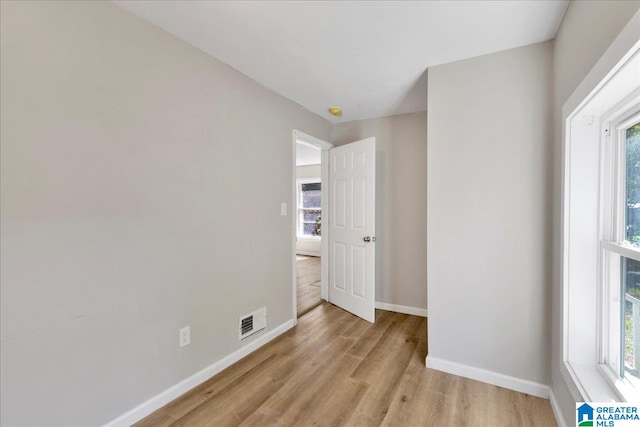 empty room with light hardwood / wood-style flooring