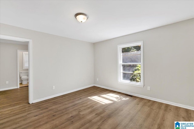 spare room with dark hardwood / wood-style floors