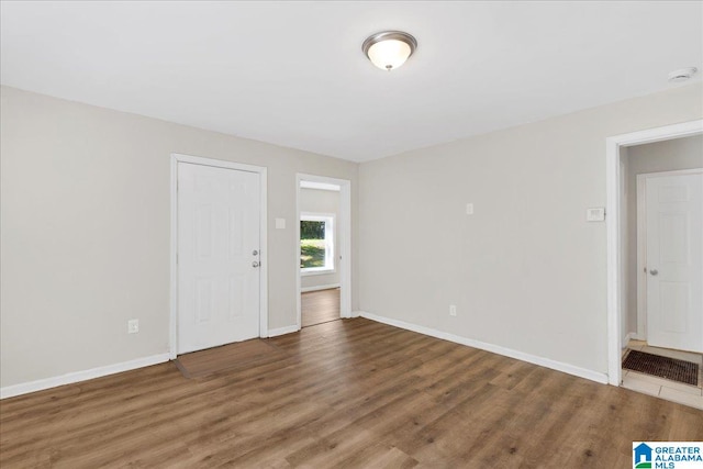 empty room with hardwood / wood-style floors