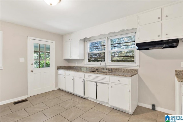 kitchen featuring sink and white cabinetry