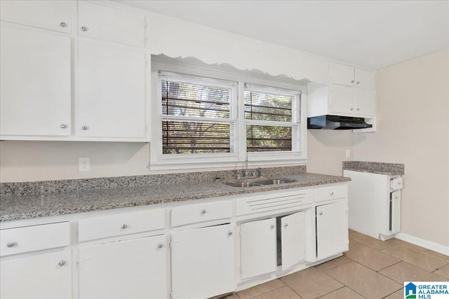 kitchen featuring white cabinets and light tile patterned floors