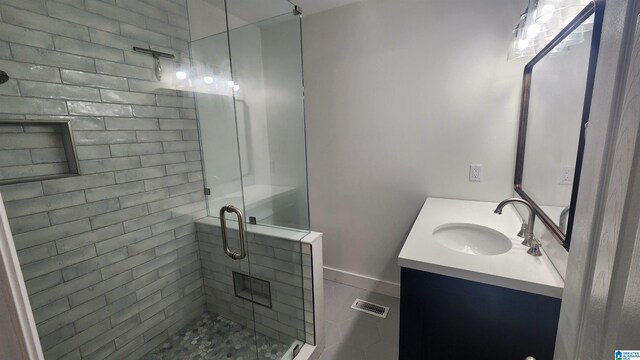 bathroom featuring an enclosed shower and vanity