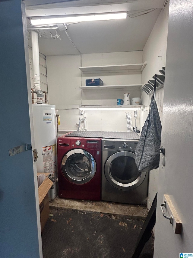 clothes washing area featuring water heater and independent washer and dryer