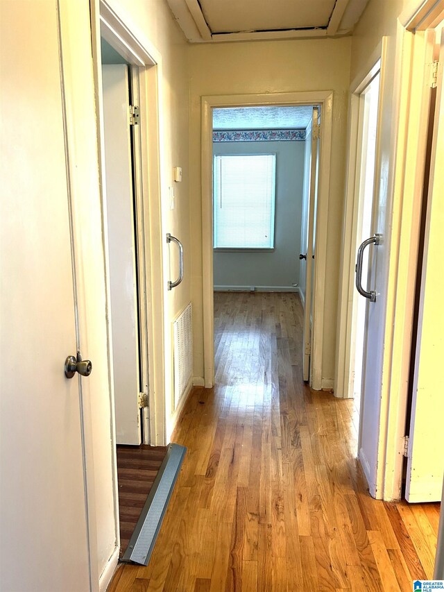 hallway with light hardwood / wood-style flooring