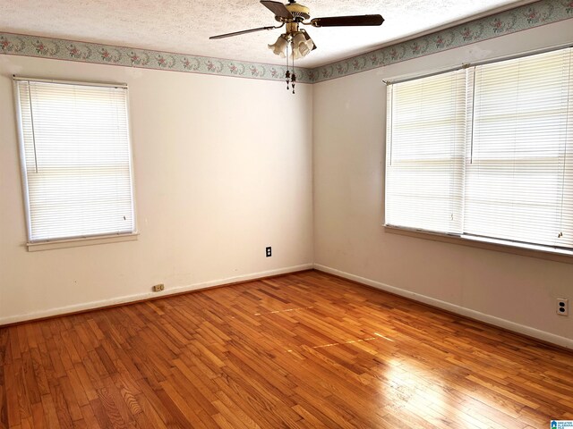 unfurnished room featuring light hardwood / wood-style flooring, ceiling fan, and plenty of natural light