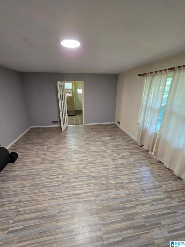 spare room with light hardwood / wood-style floors