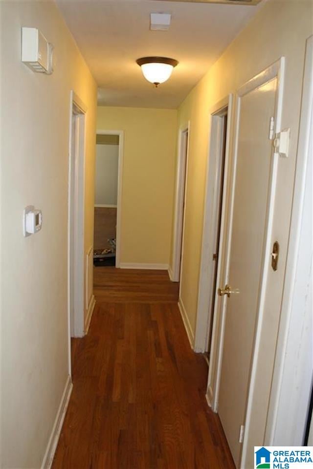 corridor with dark hardwood / wood-style floors