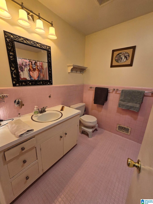 bathroom featuring tile walls, tile patterned floors, vanity, and toilet