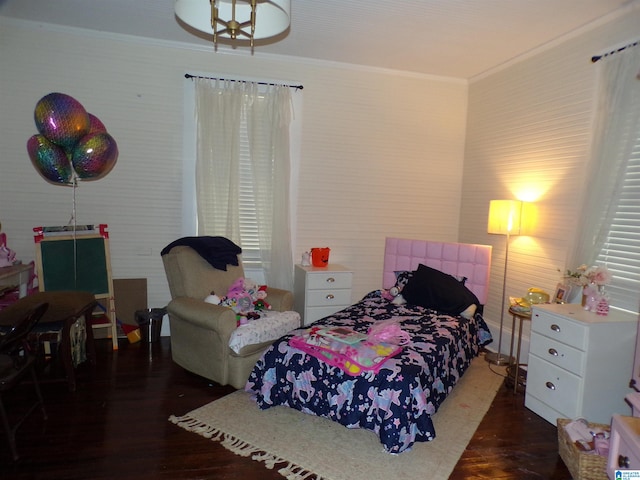 bedroom featuring ornamental molding and dark wood-type flooring