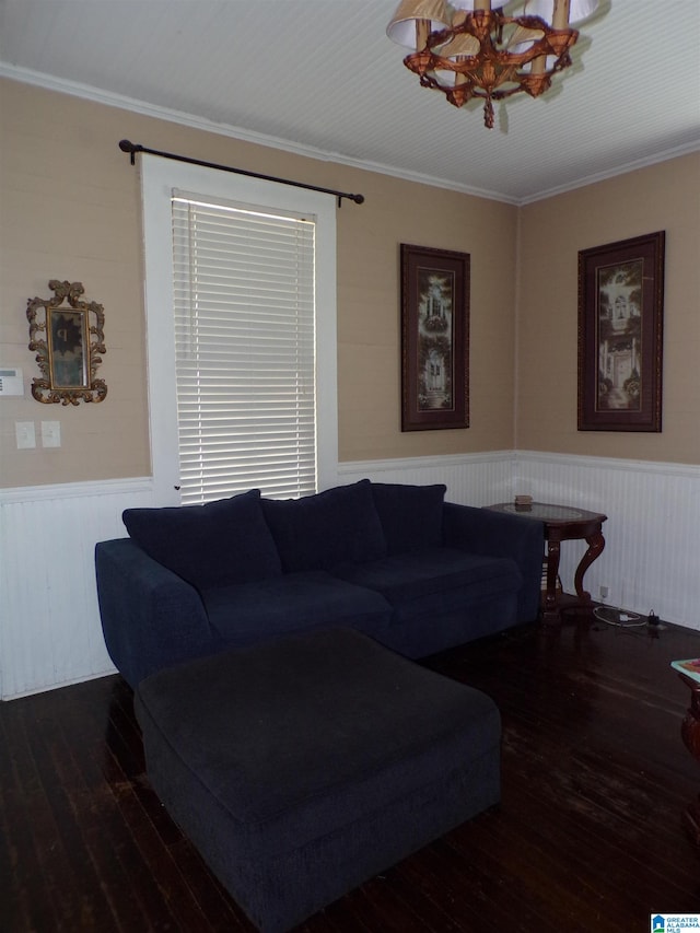 living room featuring crown molding, dark hardwood / wood-style floors, and a chandelier