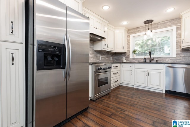 kitchen with white cabinets, stainless steel appliances, dark hardwood / wood-style flooring, and decorative light fixtures