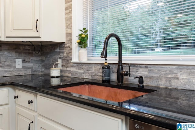 kitchen with decorative backsplash, dark stone countertops, white cabinetry, and plenty of natural light