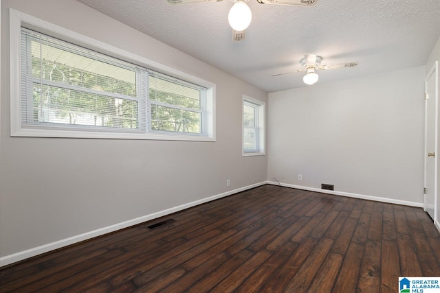 spare room featuring ceiling fan, a textured ceiling, and dark wood-type flooring