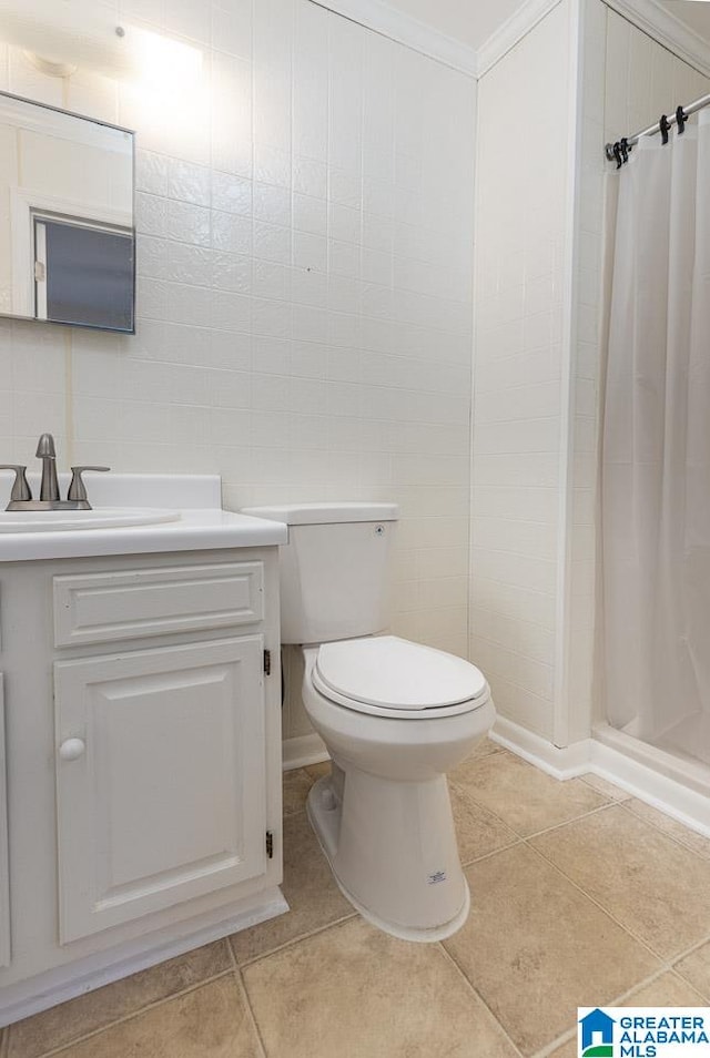 bathroom with tile patterned flooring, toilet, ornamental molding, vanity, and curtained shower