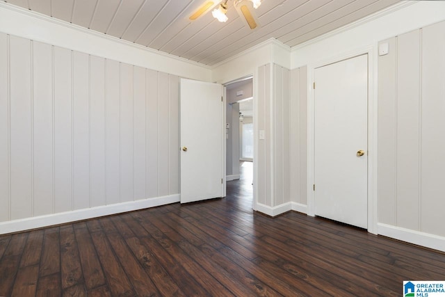 empty room featuring ceiling fan, crown molding, and dark hardwood / wood-style flooring