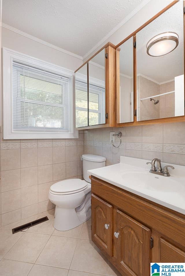 bathroom featuring ornamental molding, tile patterned flooring, vanity, and toilet