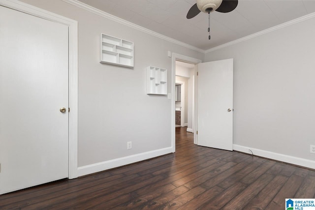 empty room featuring ornamental molding, ceiling fan, and dark wood-type flooring