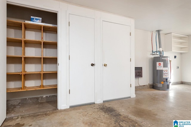 garage featuring gas water heater and heating unit