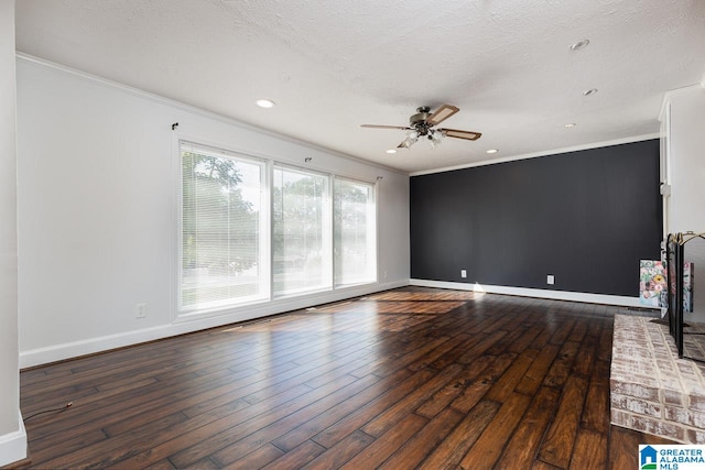 unfurnished living room featuring ceiling fan, a textured ceiling, crown molding, and dark hardwood / wood-style flooring