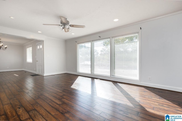 unfurnished room with ornamental molding, ceiling fan with notable chandelier, and dark hardwood / wood-style floors