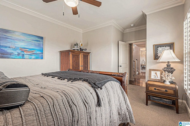 carpeted bedroom featuring crown molding and ceiling fan