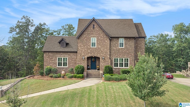 tudor house featuring a front lawn