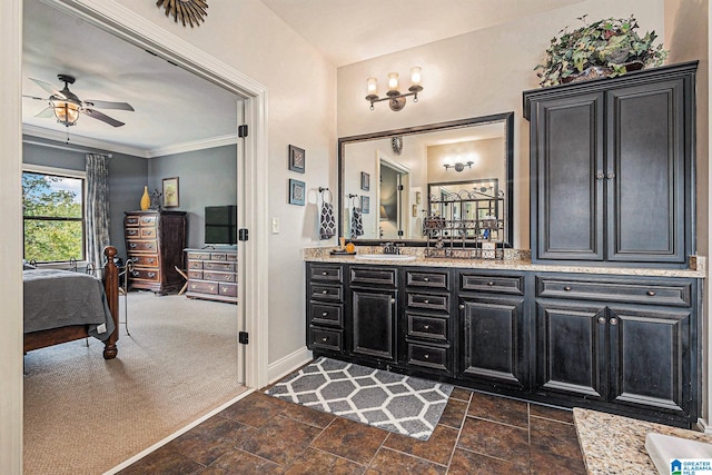 bathroom with ornamental molding, ceiling fan, and vanity