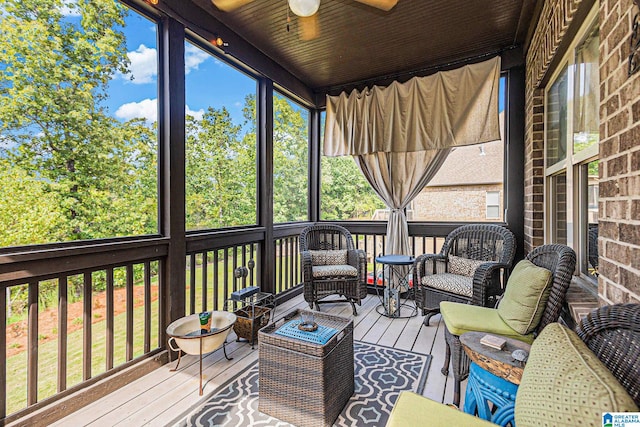 sunroom / solarium with ceiling fan and wooden ceiling