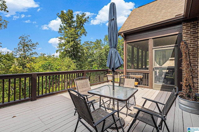 wooden deck with a sunroom