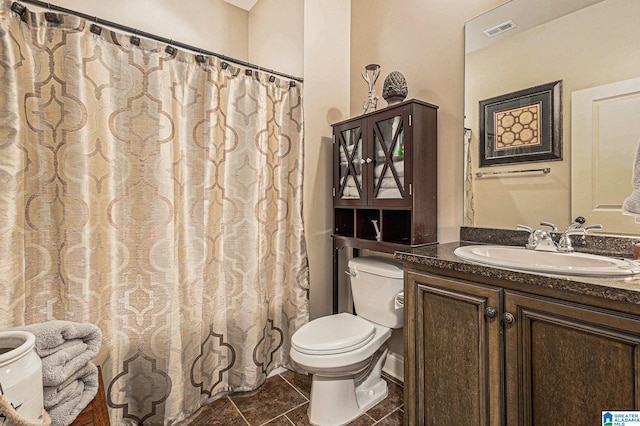 bathroom featuring vanity, tile patterned flooring, toilet, and a shower with shower curtain