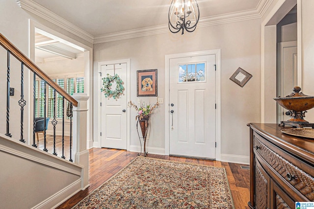 entryway featuring a notable chandelier, hardwood / wood-style floors, and crown molding