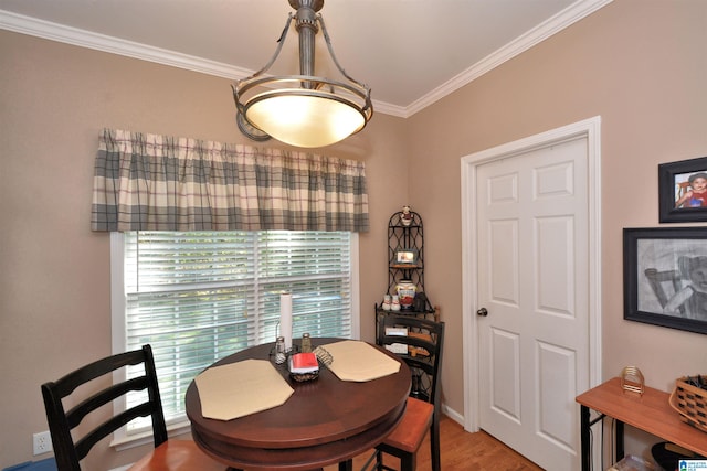 dining room with crown molding and wood-type flooring