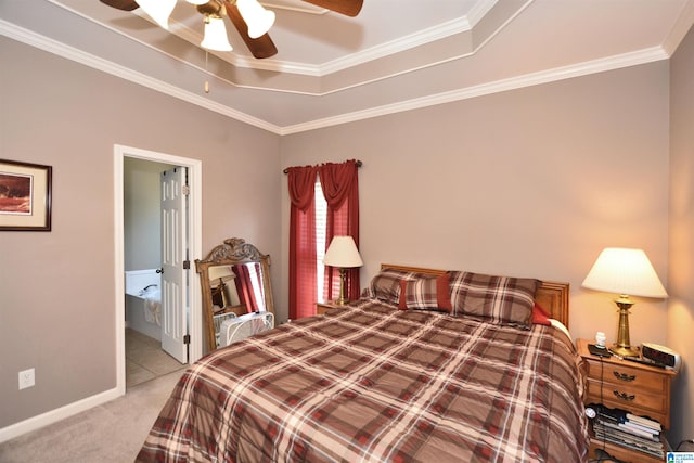 carpeted bedroom with ceiling fan, crown molding, ensuite bathroom, and a raised ceiling