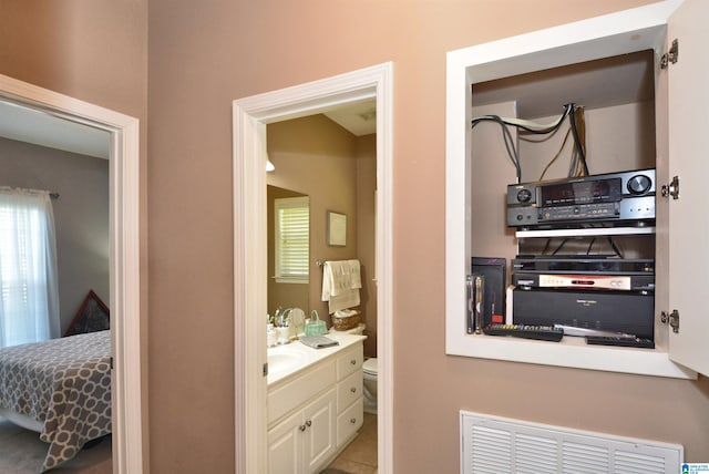 bathroom with vanity, toilet, and tile patterned floors