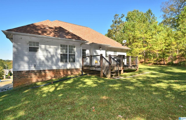 rear view of property featuring a deck and a lawn