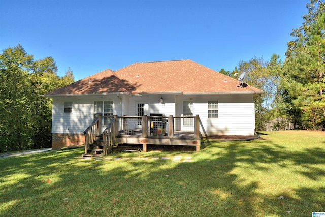 back of property with a wooden deck and a lawn