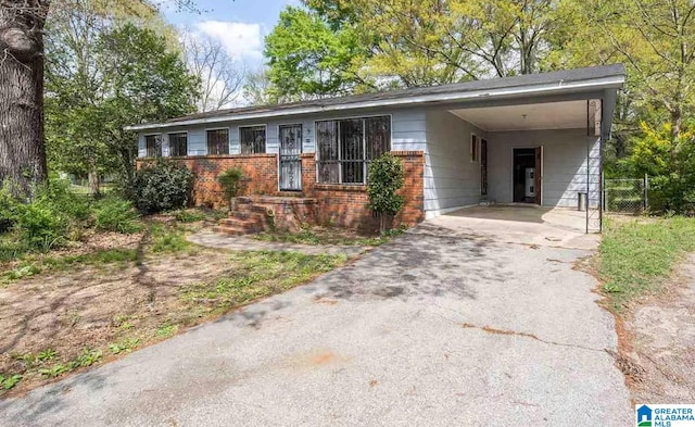 ranch-style house featuring a carport