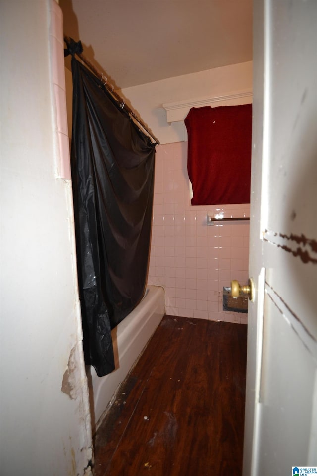 laundry room featuring dark hardwood / wood-style floors and tile walls