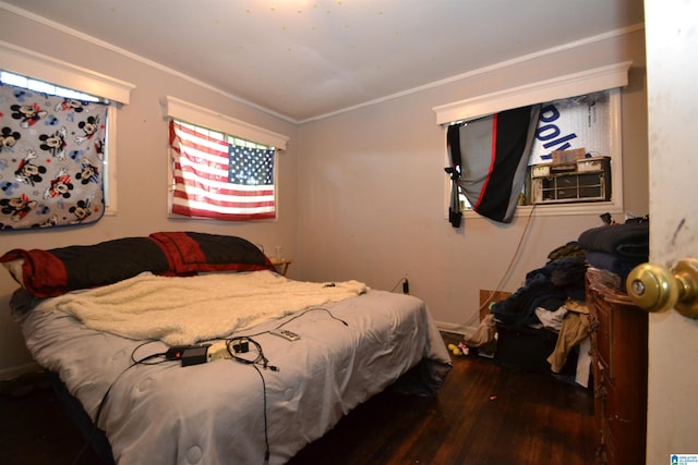 bedroom featuring dark hardwood / wood-style floors, cooling unit, and ornamental molding