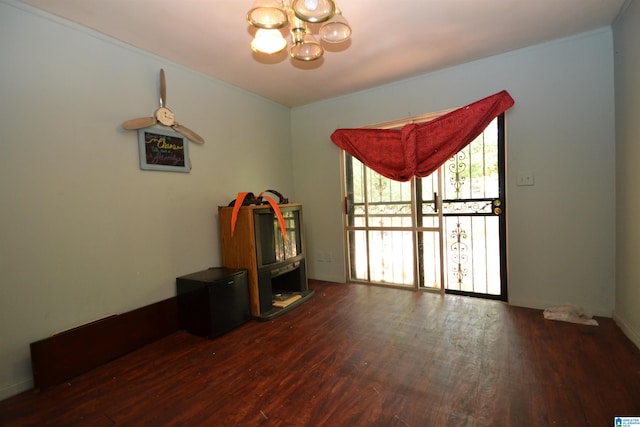 miscellaneous room with a notable chandelier and dark hardwood / wood-style floors