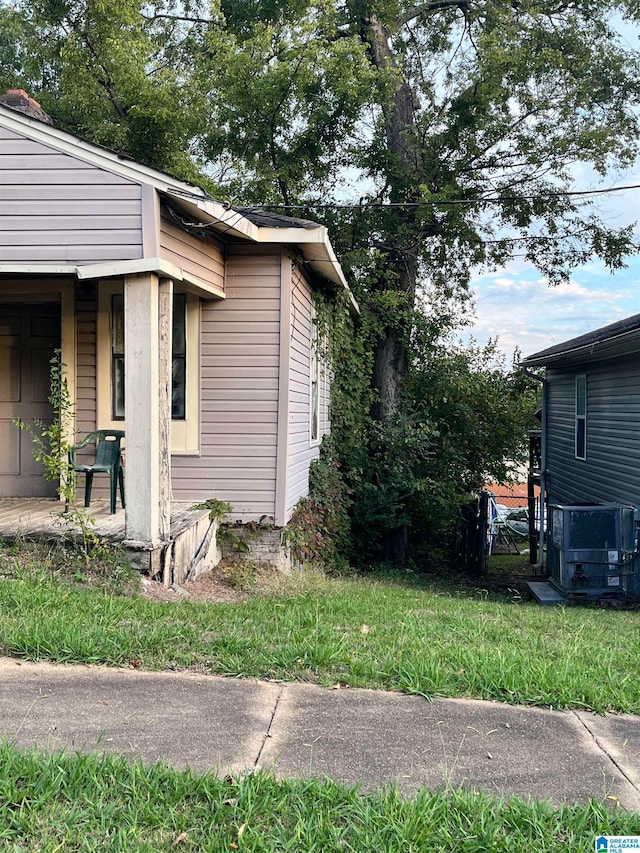 view of side of home with a lawn