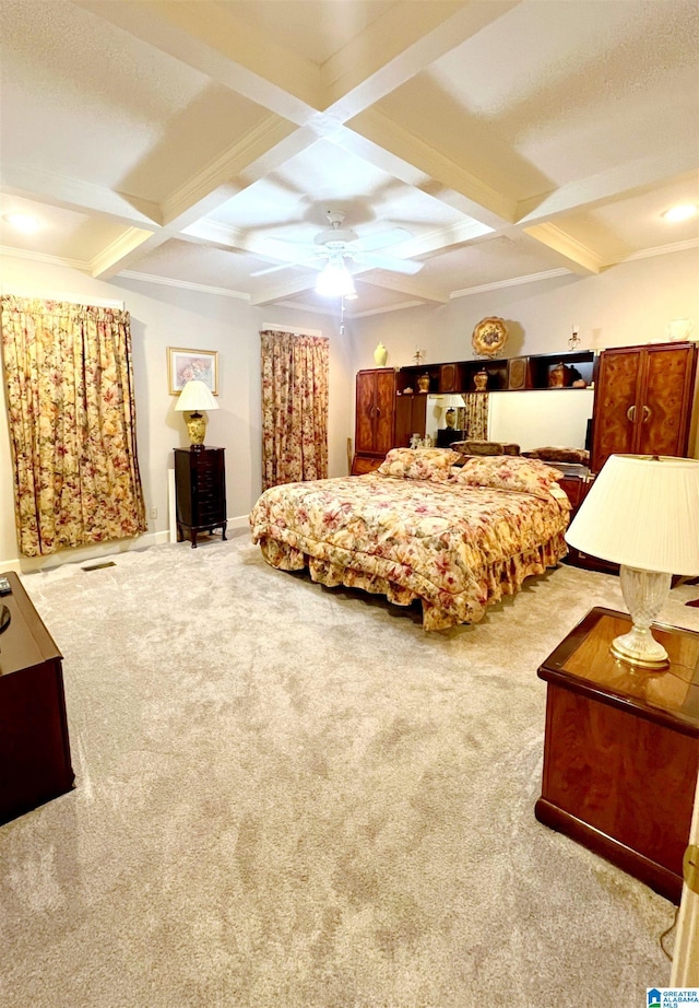 bedroom featuring light carpet, beamed ceiling, coffered ceiling, and ceiling fan