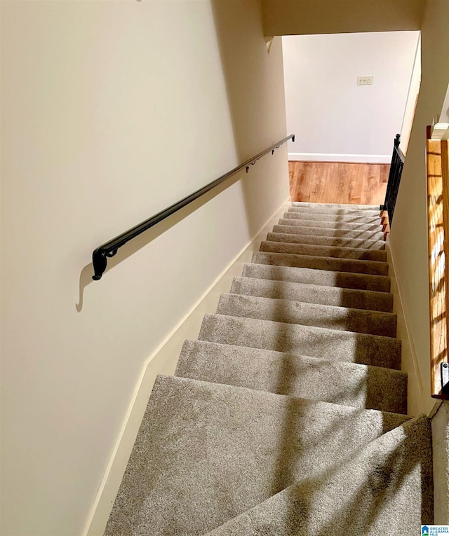 stairs featuring hardwood / wood-style flooring