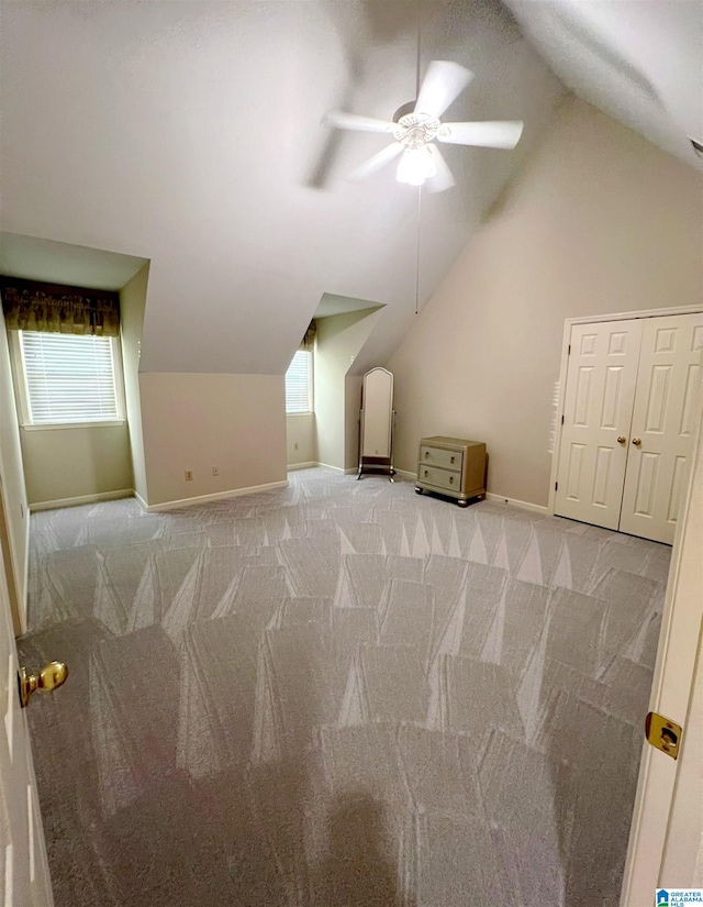 bonus room featuring lofted ceiling, light colored carpet, and ceiling fan