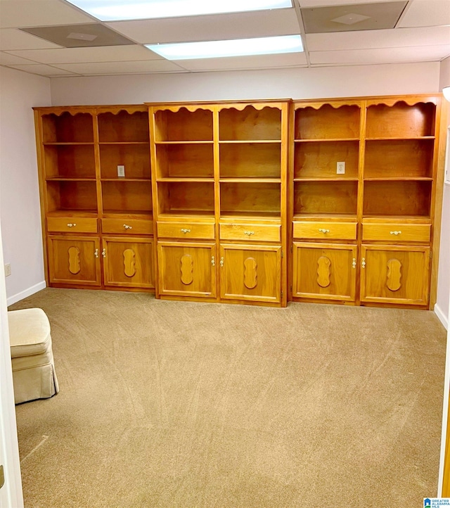 interior space featuring light carpet and a paneled ceiling