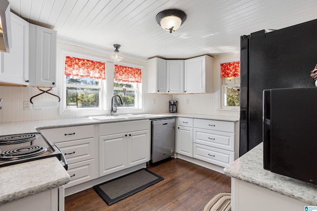 kitchen with appliances with stainless steel finishes, white cabinetry, and a wealth of natural light