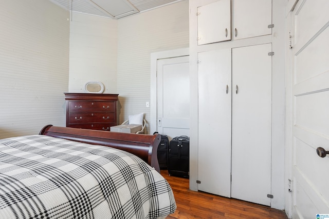 bedroom with a closet and hardwood / wood-style floors