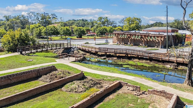 view of home's community featuring a yard and a water view