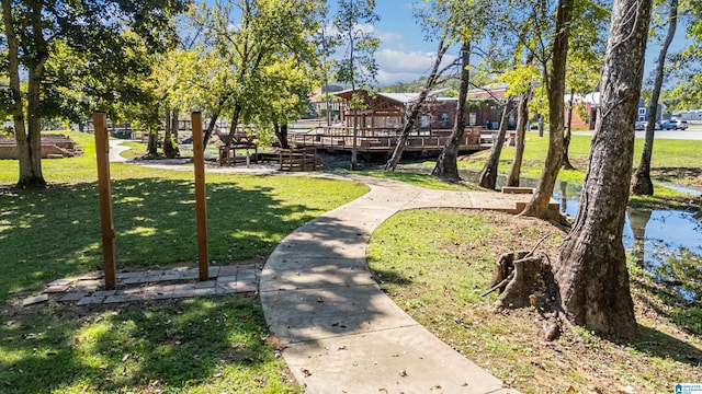 view of property's community with a deck and a lawn